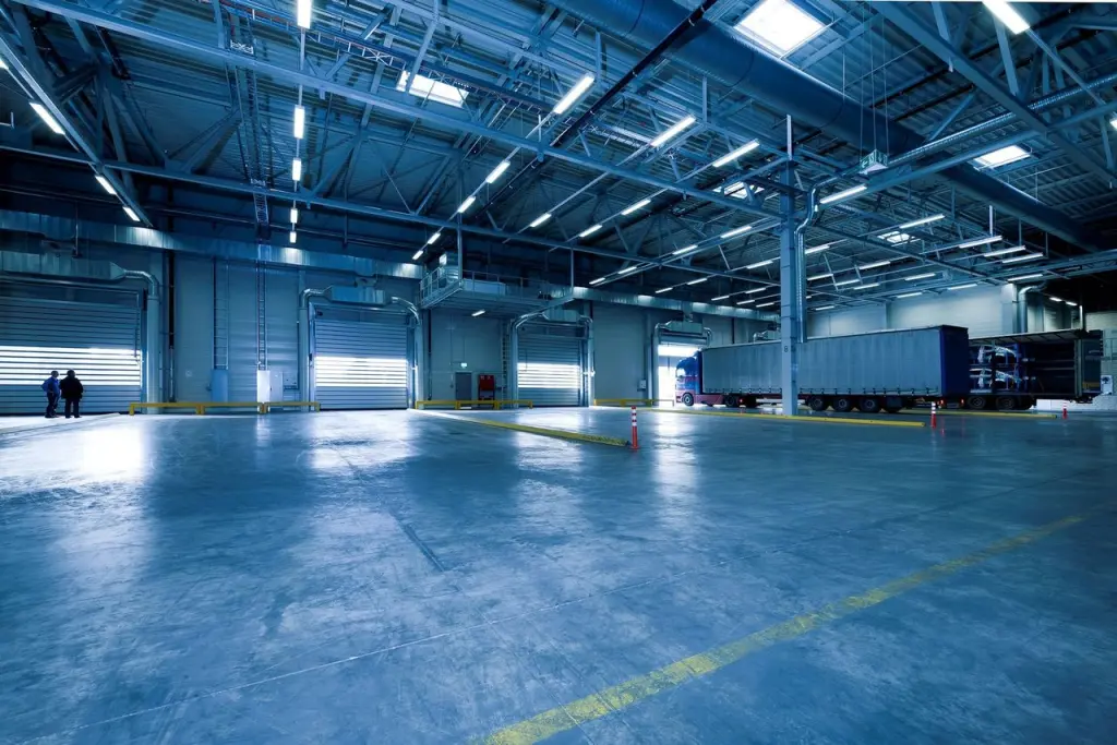 Modern distribution warehouse with loading bays and a truck